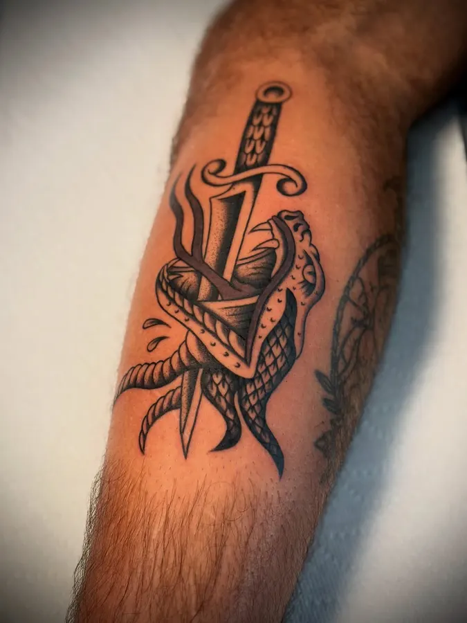 Traditional dagger surrounded by foliage.