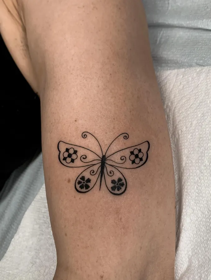 Small illustrative butterfly tattoo.