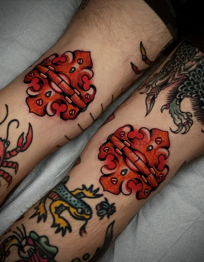 Small red traditional-style demon tattoo.