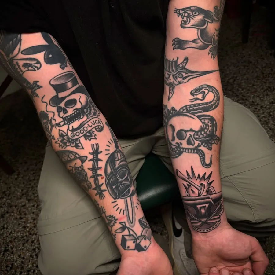 Two forearms covered in traditional motifs.